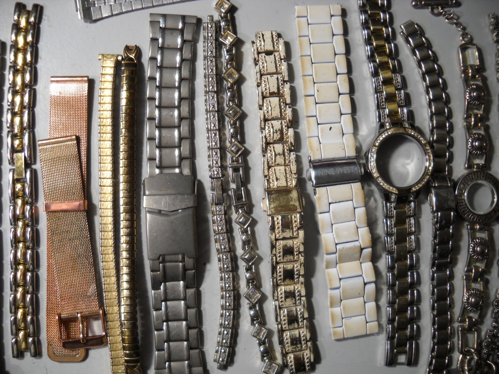 1054L Watch bands 27 piece gold color or plated ? stratch and regular look it