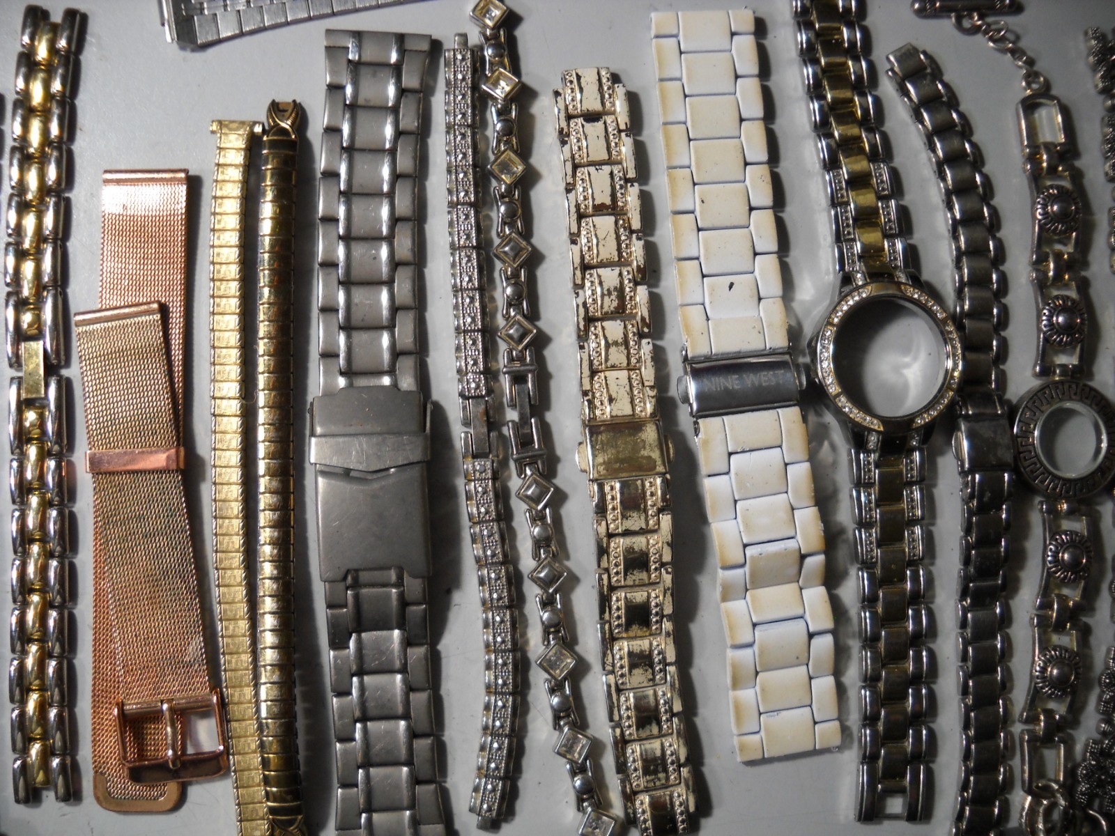 1054L Watch bands 27 piece gold color or plated ? stratch and regular look it
