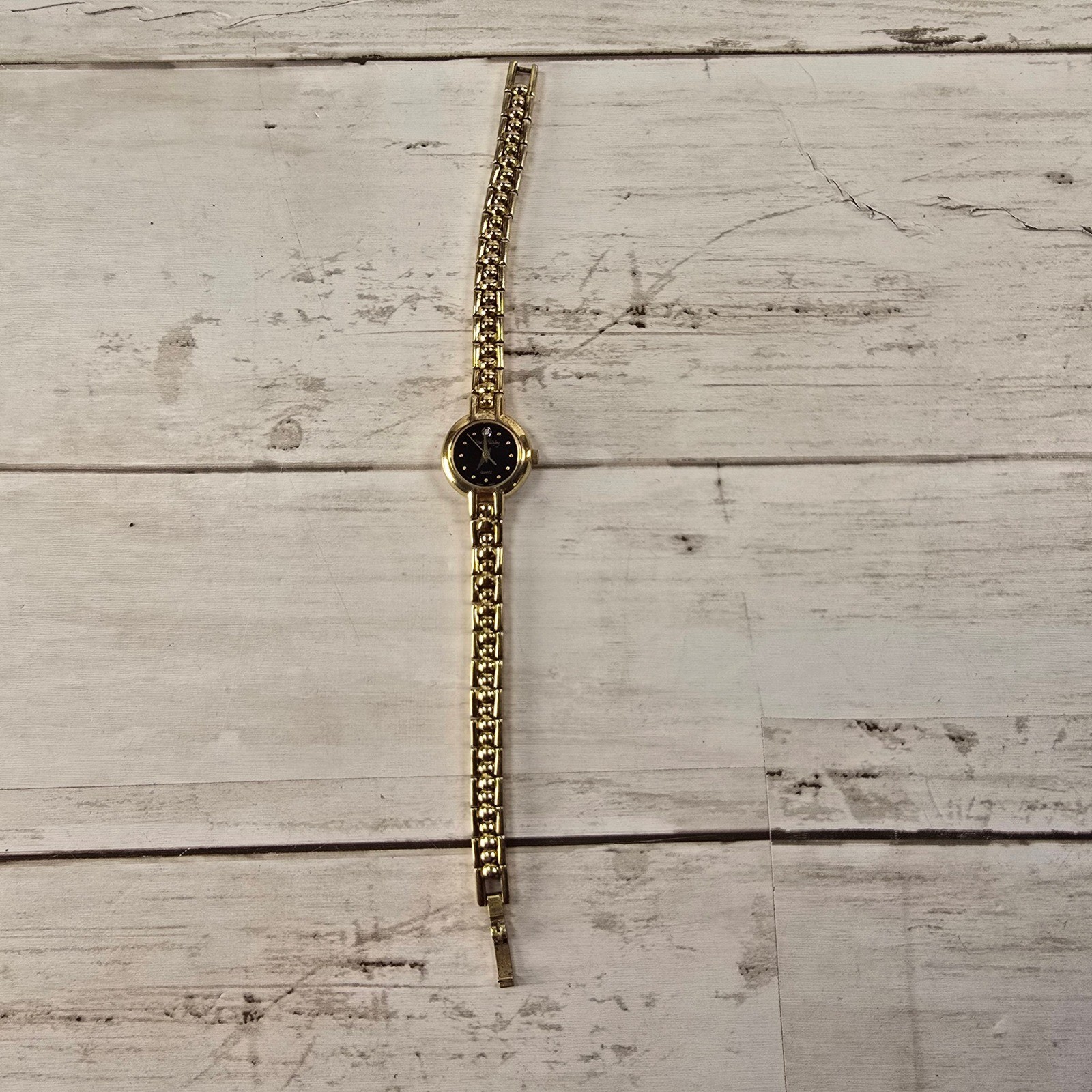 Vintage Diane von Furstenberg Gold Tone Watch Black Dial Crystal Accent Quartz