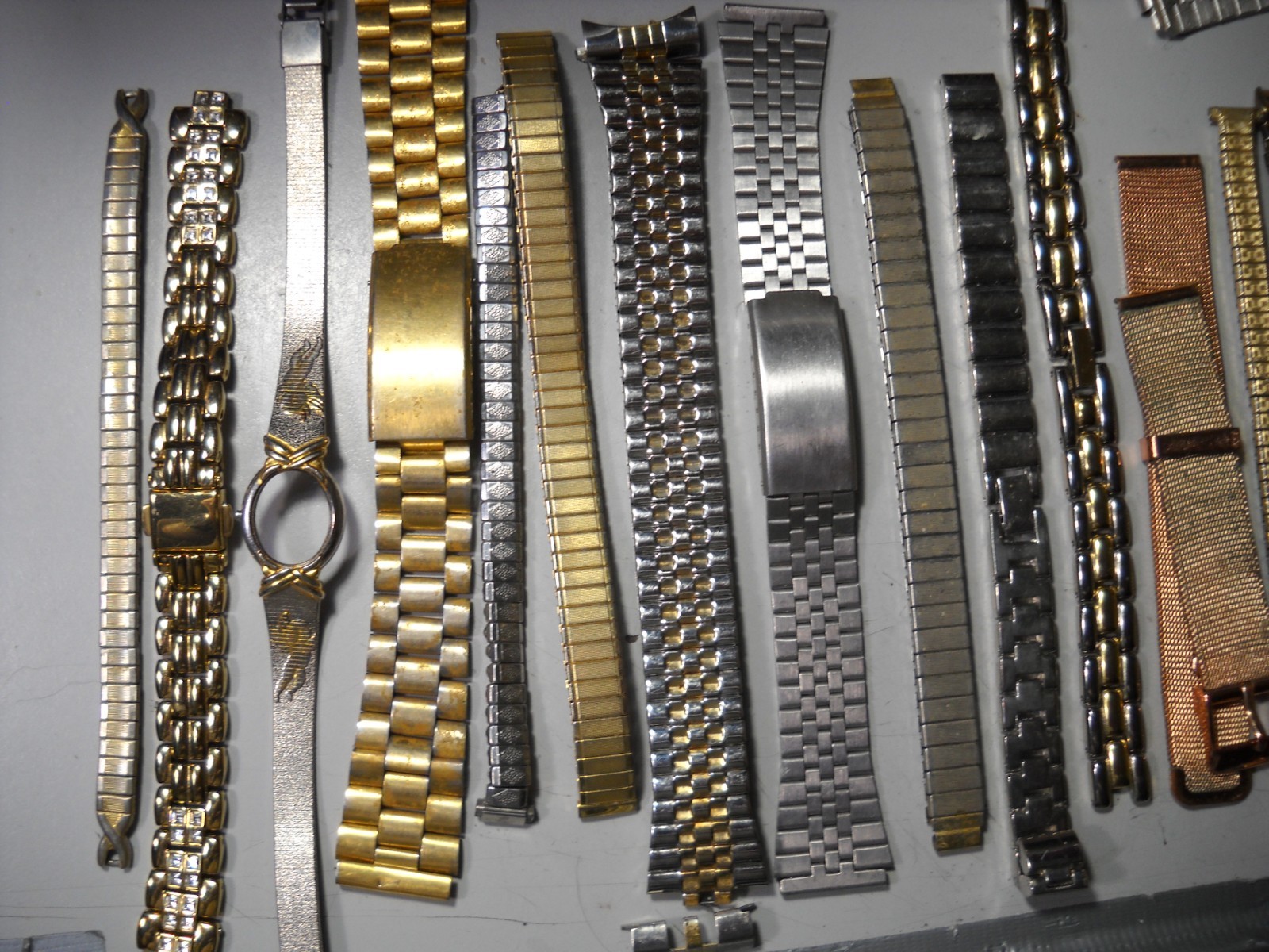 1054L Watch bands 27 piece gold color or plated ? stratch and regular look it