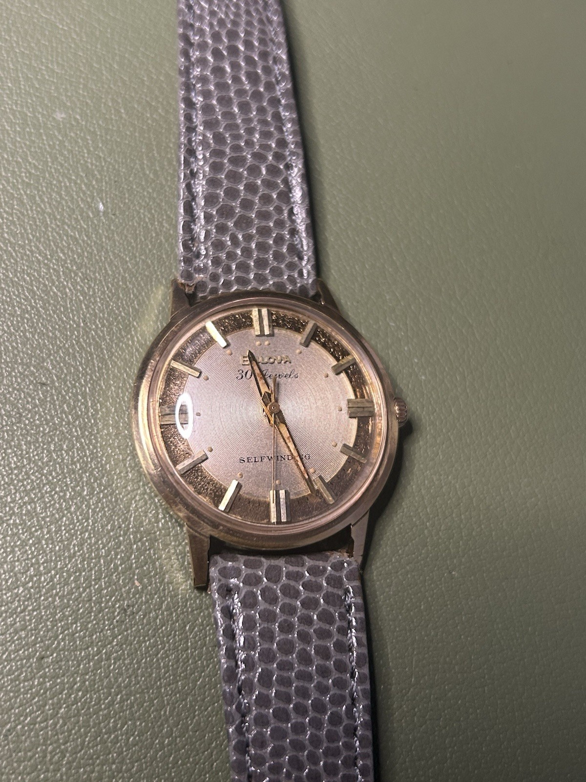 Bulova 30 Jewels Self-Winding Gold Tone Silver Dial Gray Leather Strap